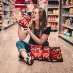 woman holding bag of chips